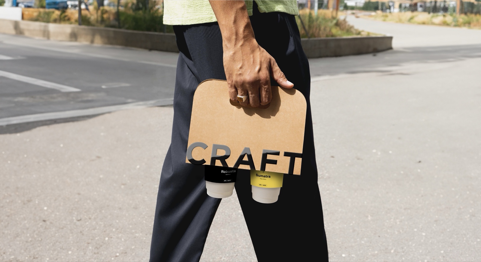Hand carrying a Craft two-cup carrier across a street