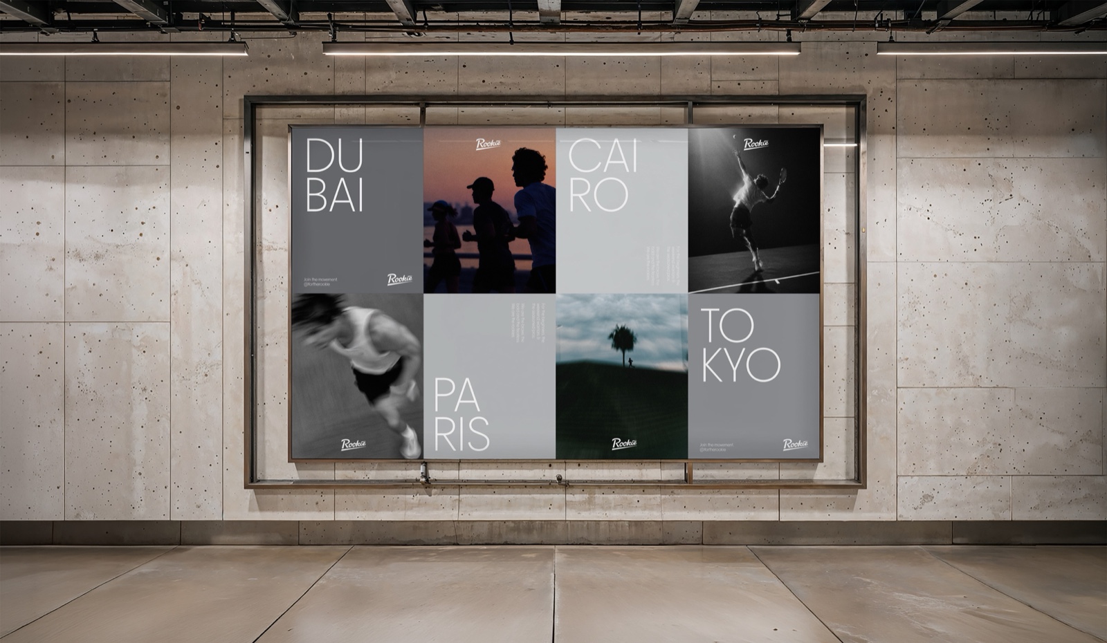 Eight Rookie city posters, Dubai, Cairo, Paris and Tokyo, in a lit frame on a concrete wall